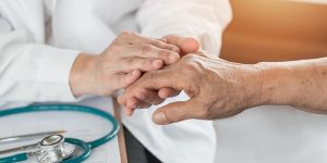 Doctor helps patient with Arthritis