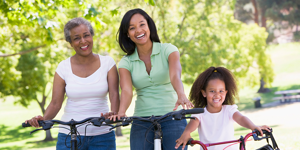 Three women riding bicycles