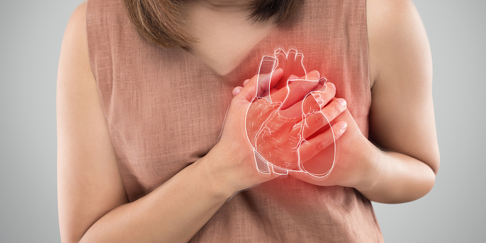 Woman holds her hands to her heart