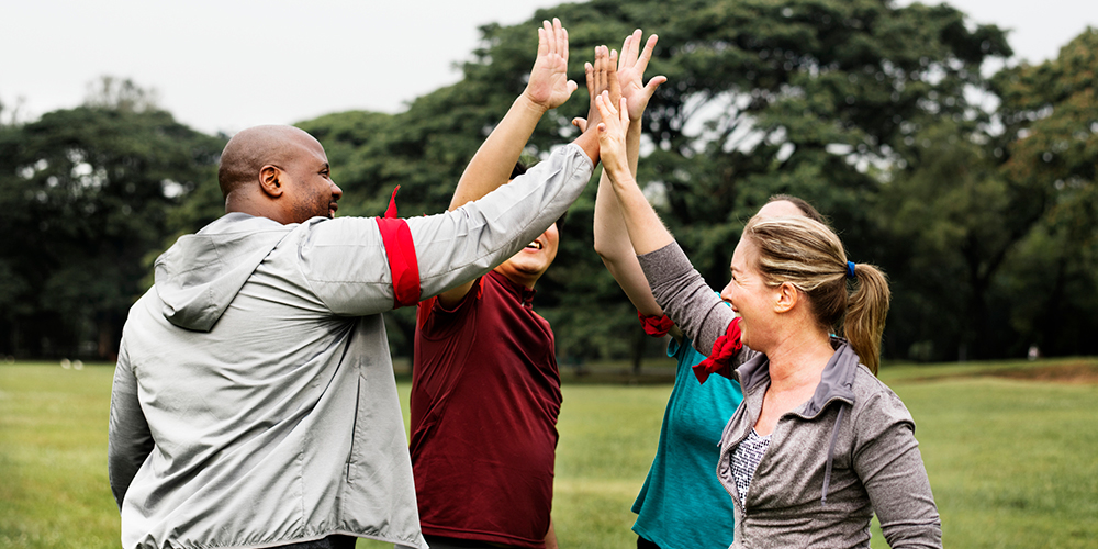 Friends high five after exercising together