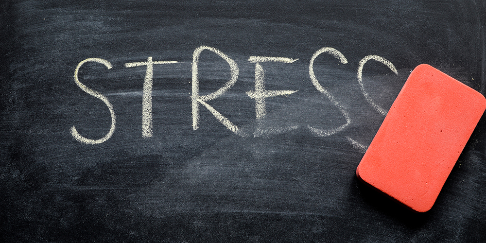 Chalkboard word "Stress" being erased